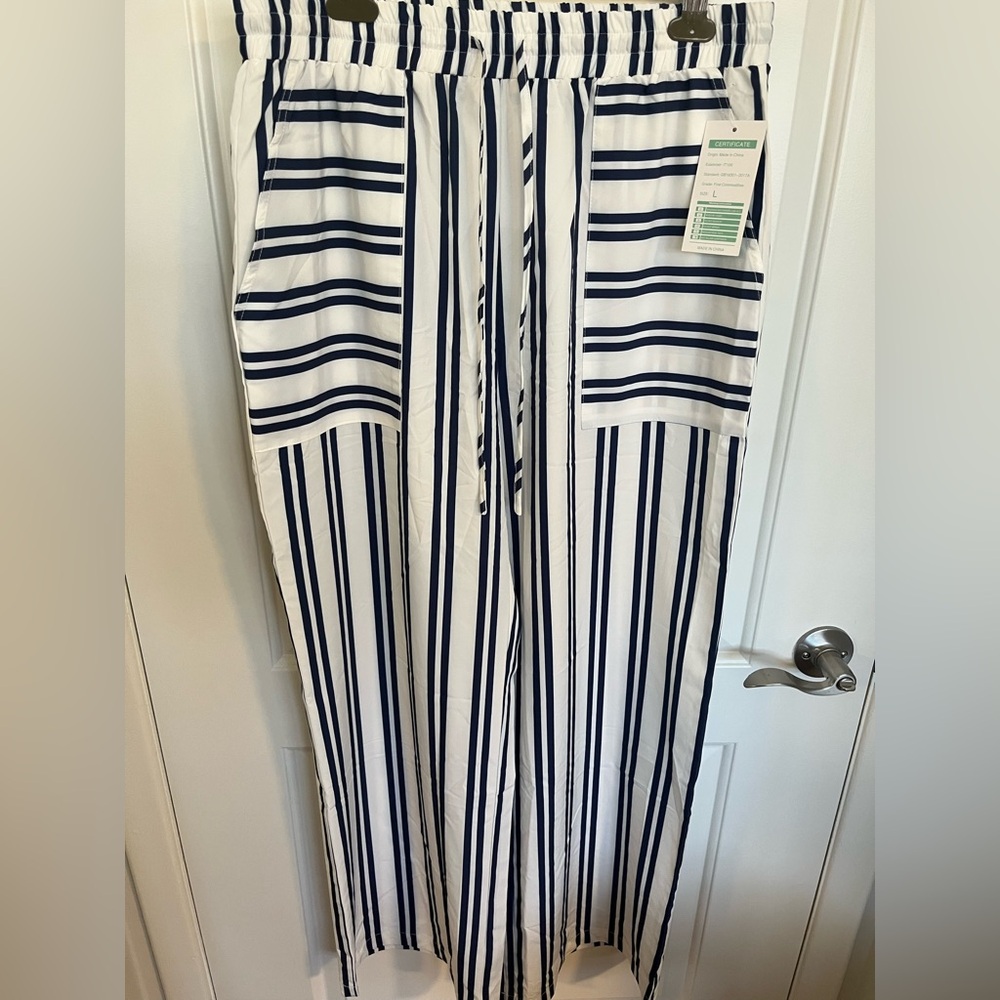 Cute wide leg white pants with navy stripes.  Pockets and draw string waist
